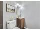 Well-appointed bathroom with a modern vanity, toilet, and decorative painting at 1388 Kenton, Aurora, CO 80010