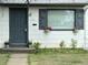 Charming home exterior features a blue door, flower boxes, and a well-maintained lawn at 1388 Kenton, Aurora, CO 80010