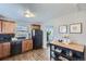 Charming kitchen featuring wood cabinets, black appliances, and stylish countertops at 1388 Kenton, Aurora, CO 80010