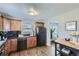 Cozy kitchen featuring wood cabinets, black appliances, and a modern countertop at 1388 Kenton, Aurora, CO 80010