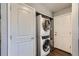 Convenient laundry area featuring modern stackable washer and dryer units, and utility storage space at 1388 Kenton, Aurora, CO 80010