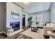 Bright living room features a decorative fireplace, hardwood floors, and comfortable seating at 1388 Kenton, Aurora, CO 80010