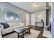 Bright living room features natural light, neutral walls, hardwood floors, and comfortable seating at 1388 Kenton, Aurora, CO 80010