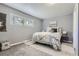 Bright main bedroom with a king bed, soft rug, and a large window at 1388 Kenton, Aurora, CO 80010