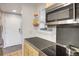 Efficient kitchen layout with modern microwave, stainless steel cooktop and light stained wood cabinets at 2636 Juniper Ave # 39-1, Boulder, CO 80304