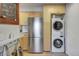 Open kitchen featuring stainless steel fridge, light wood cabinets, stackable washer/dryer and stylish decor at 2636 Juniper Ave # 39-1, Boulder, CO 80304