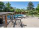 Large pool area with ample seating, pergolas, umbrellas and trees around perimeter at 2636 Juniper Ave # 39-1, Boulder, CO 80304
