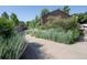 A sunny streetscape showcasing lush greenery alongside a pedestrian walkway, with a brown home partially visible at 2636 Juniper Ave # 39-1, Boulder, CO 80304