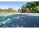 Tennis courts surrounded by tall mature trees and buildings in the background at 2636 Juniper Ave # 39-1, Boulder, CO 80304