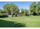 Flat grassy volleyball area surrounded by trees, buildings and residential street at 2636 Juniper Ave # 39-1, Boulder, CO 80304