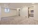 Large bedroom area with neutral colored carpet and easy access to an ensuite bathroom at 1073 W Powers Ave, Littleton, CO 80120
