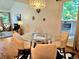 Dining room with glass table, designer lighting, and views to living area at 1073 W Powers Ave, Littleton, CO 80120