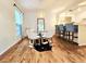 Charming dining area with a glass table, unique light fixture, and hardwood floors at 1073 W Powers Ave, Littleton, CO 80120