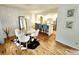 Dining area with glass table and bar seating overlooking the open kitchen area at 1073 W Powers Ave, Littleton, CO 80120