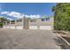 Exterior view of townhome with multiple garage doors and parking spaces at 1073 W Powers Ave, Littleton, CO 80120