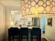 Kitchen with a breakfast bar, stainless steel appliances, and stylish pendant lighting at 1073 W Powers Ave, Littleton, CO 80120