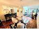 Open concept living space, including a kitchen with a bar, round table and chairs, and adjacent living room at 1073 W Powers Ave, Littleton, CO 80120
