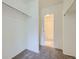 Neutral toned walk-in closet with access to a well-lit bathroom at 1073 W Powers Ave, Littleton, CO 80120