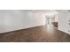 Spacious finished basement with wood tile flooring, recessed lighting, and sliding glass door to the outside at 20031 Elgin Dr, Denver, CO 80249
