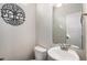 Small bathroom features a toilet and a sink, together with a mirror on the wall at 20031 Elgin Dr, Denver, CO 80249