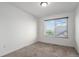 Simple bedroom with neutral carpet, white walls, and a bright window at 20031 Elgin Dr, Denver, CO 80249