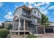 Two-story home featuring a gray garage door, blue siding and covered front porch at 20031 Elgin Dr, Denver, CO 80249