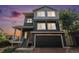 Two-story home featuring a black garage door, blue siding and covered front porch at 20031 Elgin Dr, Denver, CO 80249