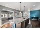 Bright kitchen with a large island, stainless steel sink, and is open to the living room at 20031 Elgin Dr, Denver, CO 80249