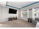 Bright living room with a large TV, electric fireplace and large windows for natural light at 20031 Elgin Dr, Denver, CO 80249