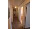 Hallway featuring a laundry closet with a stacked washer/dryer and a door to the bathroom at 2793 Roslyn St, Denver, CO 80238