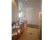 View of the kitchen with laminate countertops and white appliances, next to an empty living area at 2793 Roslyn St, Denver, CO 80238