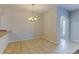 Dining room with chandelier, tile flooring, and open access to front entry at 7450 Lowell Blvd # B, Westminster, CO 80030