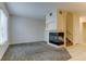 Bright living room with neutral carpet and tile flooring, complemented by a cozy fireplace and staircase at 7450 Lowell Blvd # B, Westminster, CO 80030