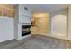 Inviting living space featuring a fireplace with carpet and tile flooring transitioning to an open-concept kitchen at 7450 Lowell Blvd # B, Westminster, CO 80030