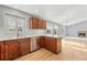 Bright kitchen with wood cabinets, quartz countertops, a modern faucet, and a view of the living room fireplace at 42926 Vista Rdg, Parker, CO 80138