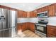 Modern kitchen featuring stainless steel appliances and wood cabinets at 42926 Vista Rdg, Parker, CO 80138