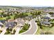 Scenic aerial view of a community featuring homes with lush green spaces, mature trees, and winding roads at 2115 Holmby Ct, Castle Rock, CO 80104