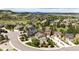 Aerial shot of luxury homes with landscaping and winding roads surrounded by rolling hills and scenic views at 2115 Holmby Ct, Castle Rock, CO 80104