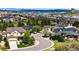 Neighborhood view with a winding street surrounded by lush greenery, mature trees, and well-kept homes at 2115 Holmby Ct, Castle Rock, CO 80104