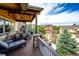 Spacious covered deck offers scenic views and outdoor dining with stone pillar accents at 2115 Holmby Ct, Castle Rock, CO 80104
