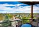 Enjoy the views from the covered back deck with outdoor dining and stone accents on the railing at 2115 Holmby Ct, Castle Rock, CO 80104