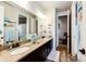 The bathroom features dual sinks with granite counters and framed mirrors at 2115 Holmby Ct, Castle Rock, CO 80104