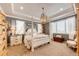 Spacious main bedroom with a four-poster bed, soft lighting, and neutral decor at 2115 Holmby Ct, Castle Rock, CO 80104
