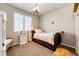 The bedroom features a bed next to a window and a chandelier overhead at 2115 Holmby Ct, Castle Rock, CO 80104