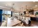 Dining area features a rustic table, chandelier lighting, and kitchen view with island seating at 2115 Holmby Ct, Castle Rock, CO 80104