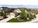 Tan two-story home with a two car garage and a well manicured lawn at 2115 Holmby Ct, Castle Rock, CO 80104