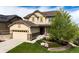 Charming two-story home with a two-car garage, manicured lawn, and attractive landscaping at 2115 Holmby Ct, Castle Rock, CO 80104