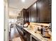 Stylish kitchen with dark cabinetry, granite counters, stainless appliances, and convenient beverage cooler at 2115 Holmby Ct, Castle Rock, CO 80104