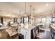 Open kitchen and dining area with a granite island, stainless steel appliances, and hardwood floors at 2115 Holmby Ct, Castle Rock, CO 80104