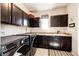 The laundry room features dark cabinets and a sink at 2115 Holmby Ct, Castle Rock, CO 80104